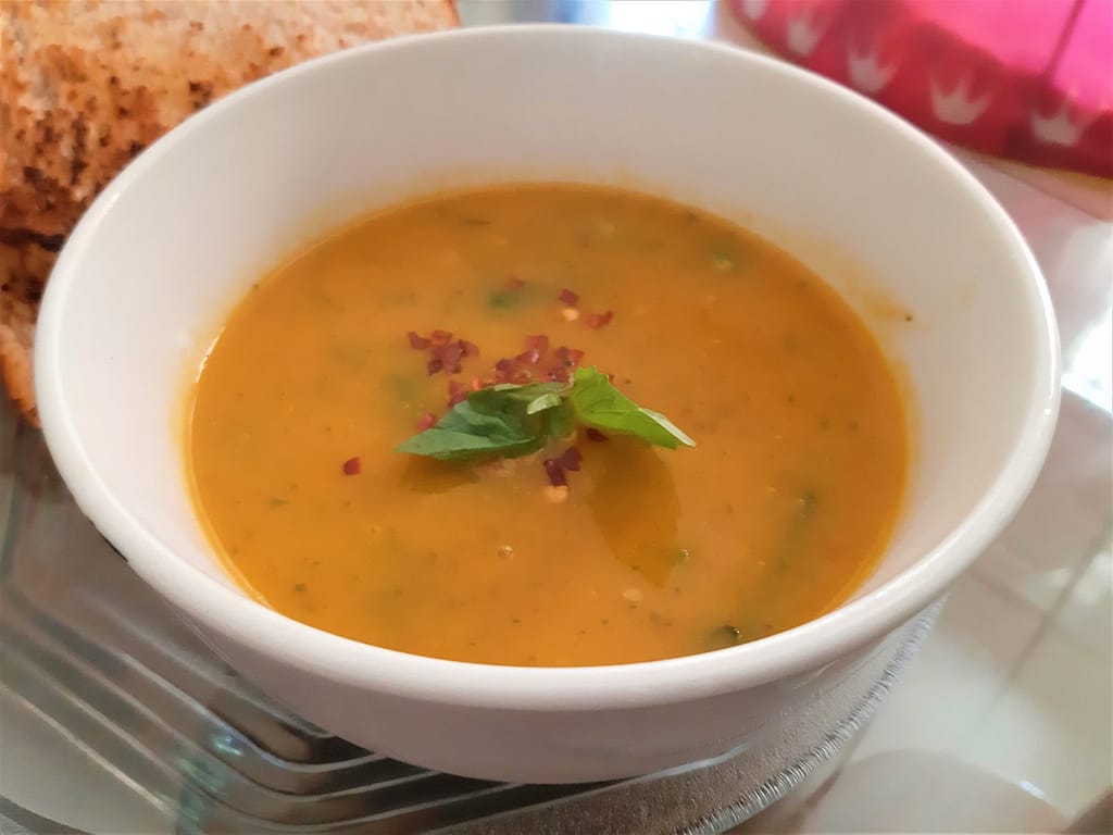 Fresh and spicy tomato carrot basil soup. Completely vegan and dairy-free.
