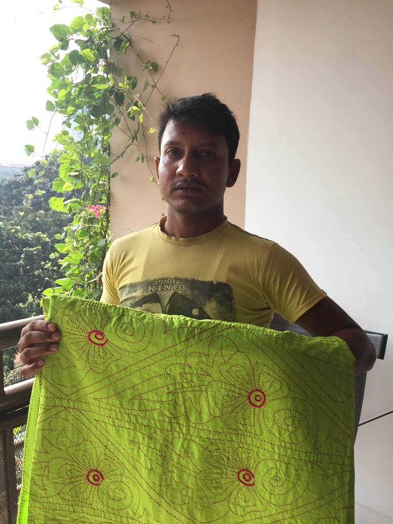 Nakshi Kantha trader Mohammed Hussain with one of his beautiful wares